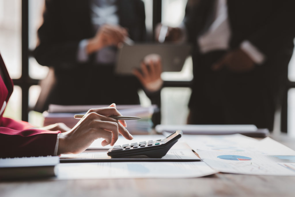 Group business people are reviewing monthly sales documents analysis and marketing plans for more sales growth, they are the founders of young companies co-founding startups. Sales management concept.