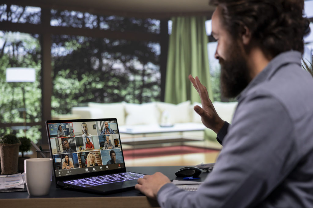 Chairman meeting with partners on videocall connection at home, attending online briefing session to present international expansion ideas. Director pitching global strategies to his team.