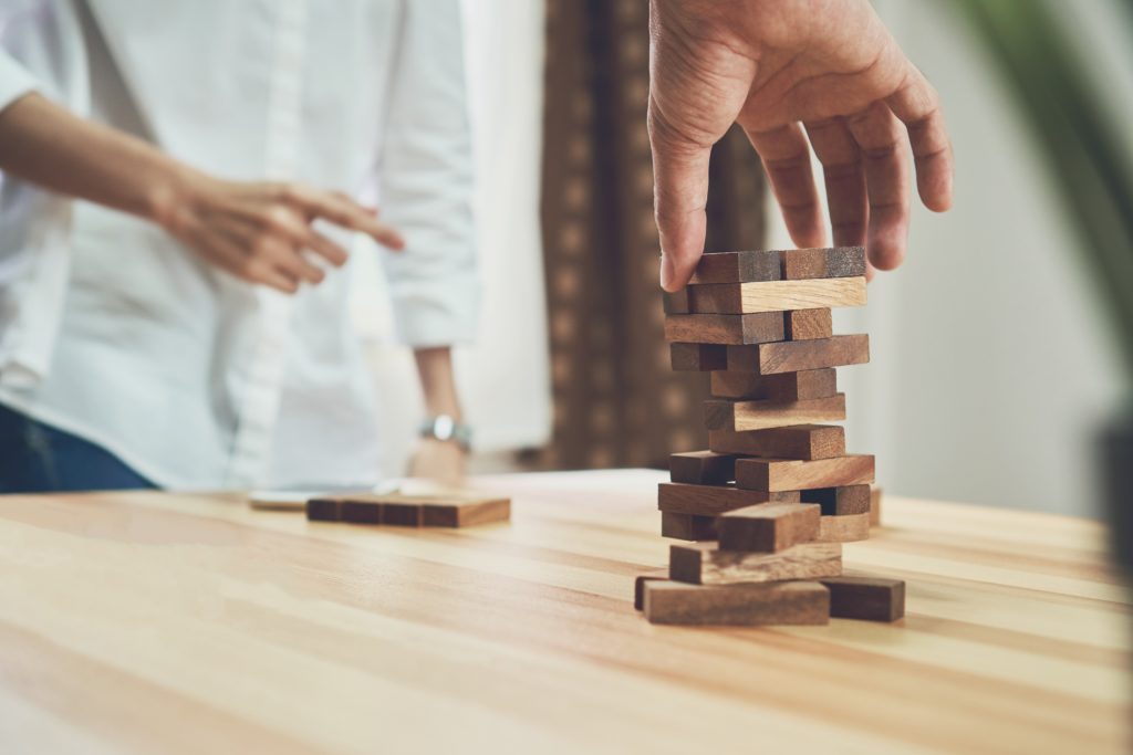 women and teamwork making a pyramid with empty wooden cubes. Business concept with step-by-step for a firm basis.